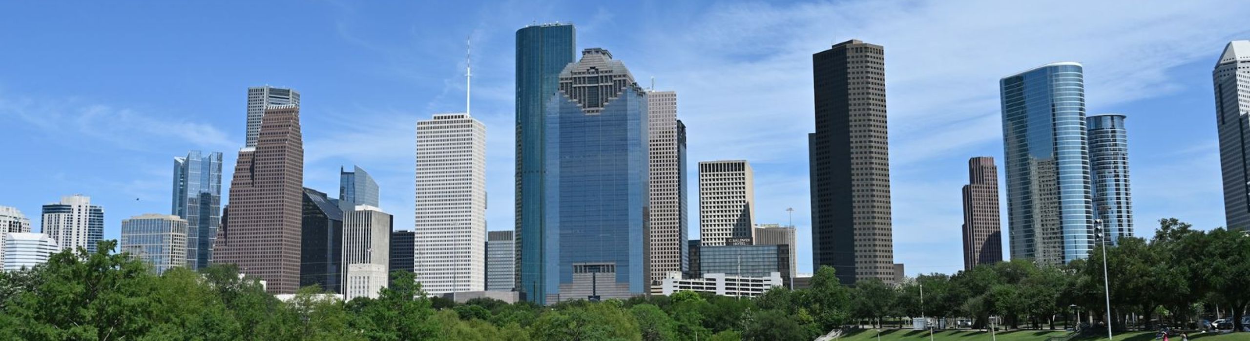 Downtown Houston skyline on a sunny day seen from a green park