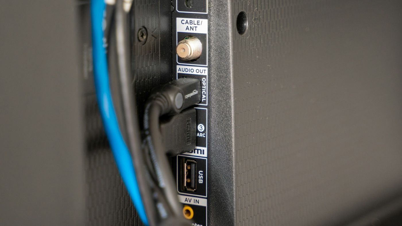 Cables connected to the input panel on the back of a television