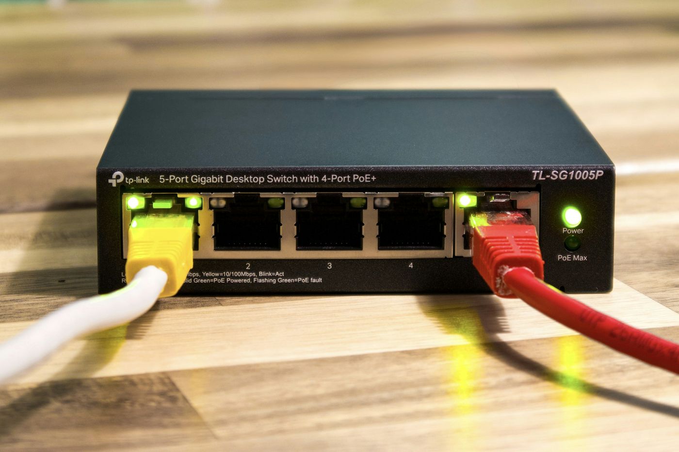 Network switch with yellow and red Ethernet cables connected
