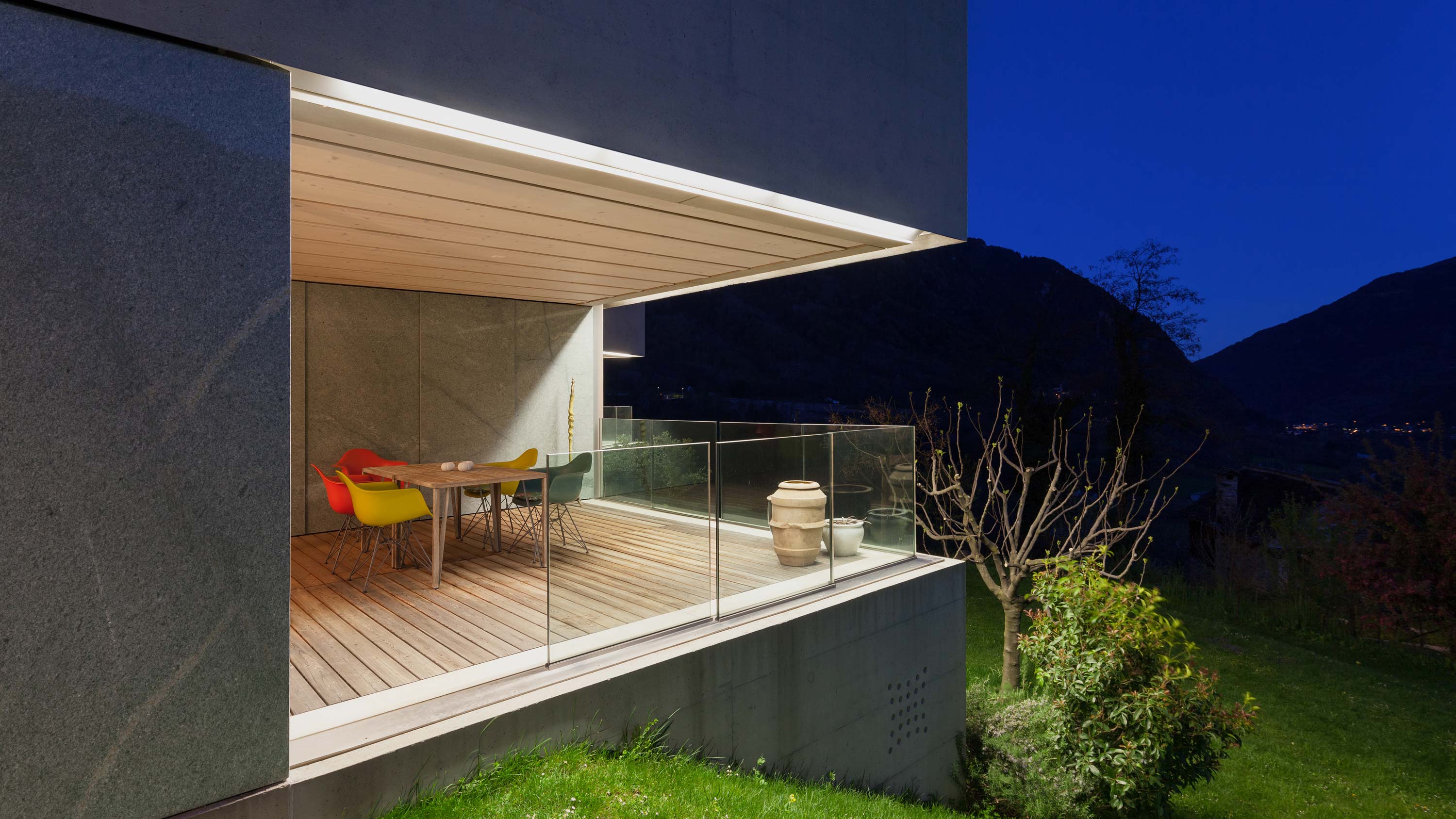 A patio with modern lighting creating a cozy evening ambiance.